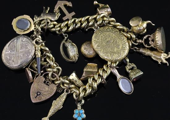 A 9ct gold charm bracelet, hung with twenty one assorted charms, gross 51 grams.